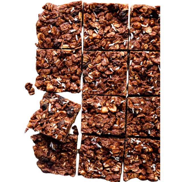 12 oat slices on a table with a hand reaching for a single oat slice